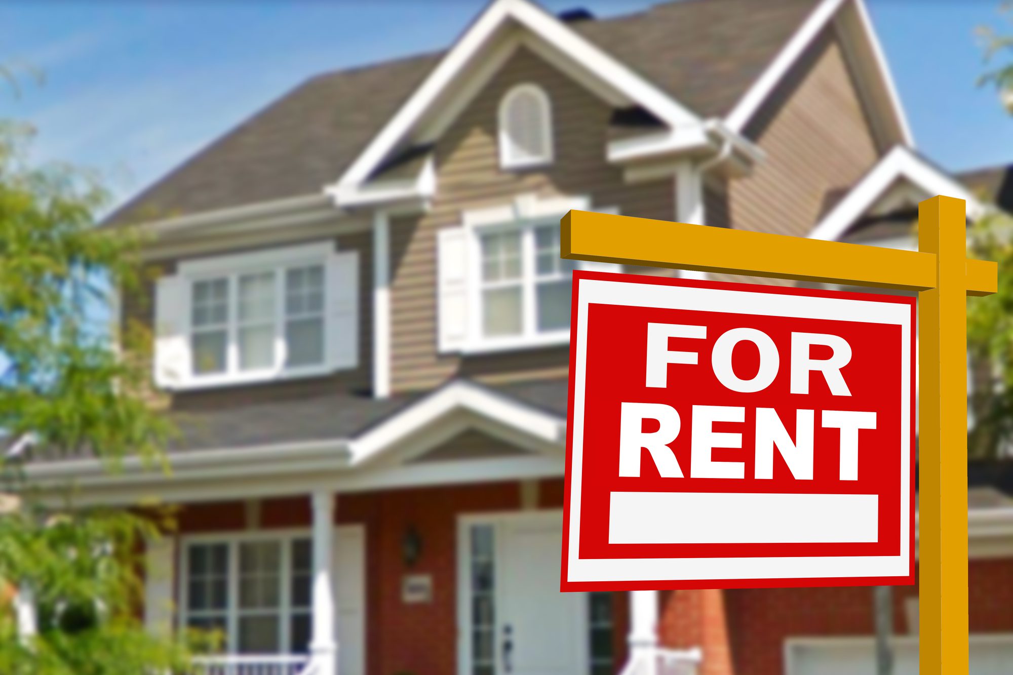 A Two-Story House With a “For Rent” Sign in the Front Yard.